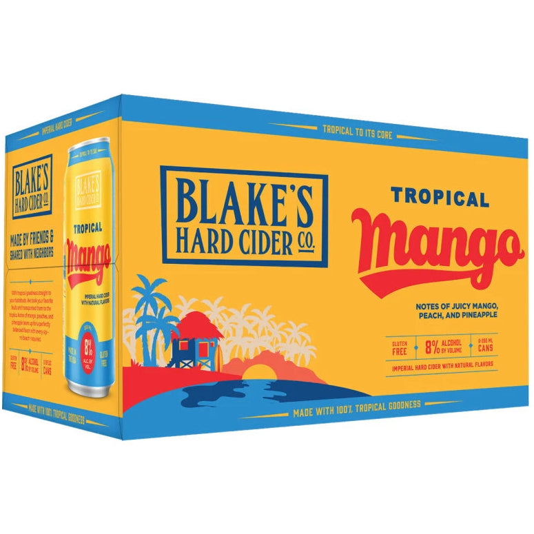 A 24-pack cardboard box of Blake's Hard Cider Co. Tropical Mango non-alcoholic fruit cider, featuring a bright yellow and blue tropical beach illustration on the packaging.